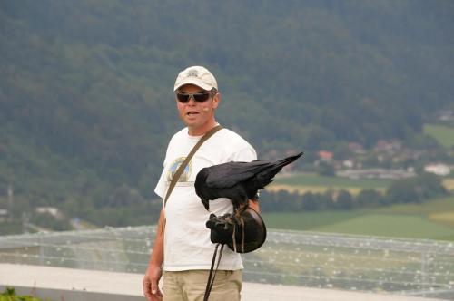 a man with a black bird on his shoulder at Gästehaus Trink B&B in Drobollach am Faakersee