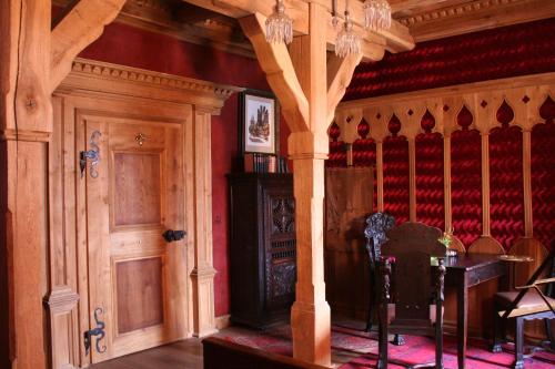 a room with a fireplace and a table and chairs at Klausenhof in Bornhagen