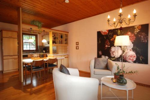 a living room with a couch and a dining room at *Appartement Elfie* Kärntner Seen (nähe Velden) in Velden am Wörthersee