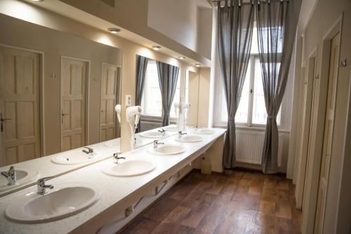 a bathroom with four sinks and a large mirror at Onefam Old Town in Prague