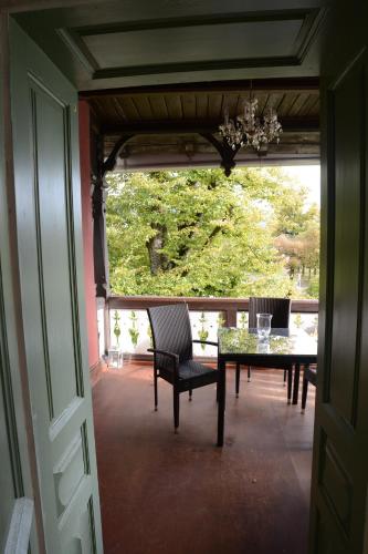 a dining room with a table and chairs on a porch at Villa Streintz in Millstatt