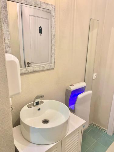a bathroom with a white sink and a toilet at Vila Montana Valiug in Văliug