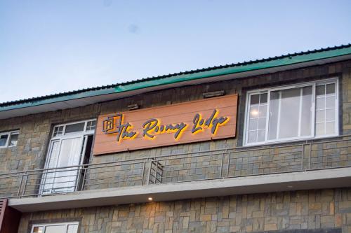 a sign on the side of a building at The Roomy Lodge, Murree in Murree