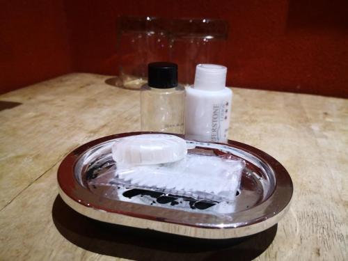 a container of soap and a bottle on a table at Riverstone Lodge in Muldersdrift