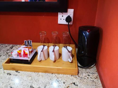a wooden cutting board with three glass bottles on a counter at Riverstone Lodge in Muldersdrift