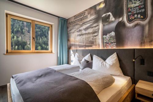 a bedroom with a bed with a poster on the wall at Seebrunn - Außere Schwemmalm in Ultimo