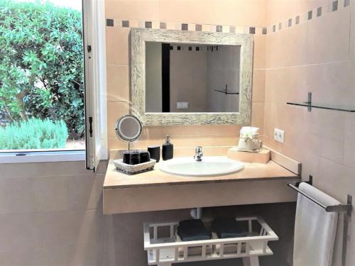 a bathroom with a sink and a mirror and a window at Apartment En Capillo in Manacor