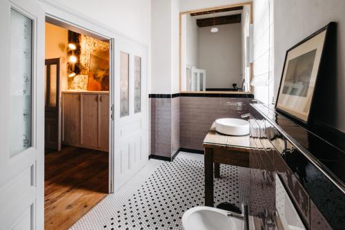 a bathroom with two sinks and a glass counter at Boutique hotel Corso in Řevnice