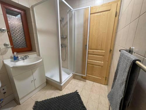 a small bathroom with a shower and a sink at Apartmány SKI Čertovica in Vyšná Boca