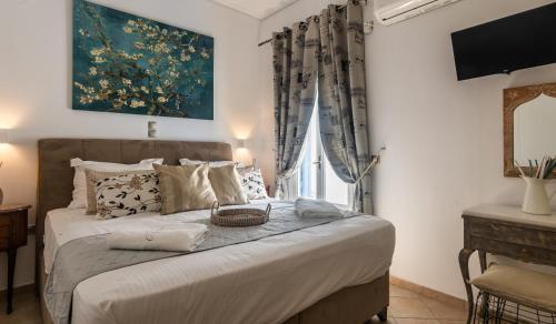 a bedroom with a large bed with a window at ARTEMIS by Akroploro in Pollonia