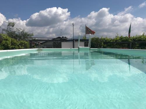 a large pool of blue water in front of a building at Borgo Piccolo in Cavaion Veronese