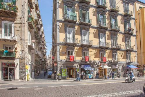a building on a street with people walking on the street at B&B L'Alloggio Dei Vassalli in Naples