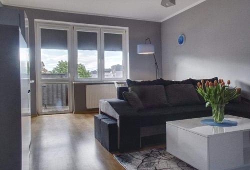 a living room with a couch and a coffee table at M&S Apartament in Świnoujście