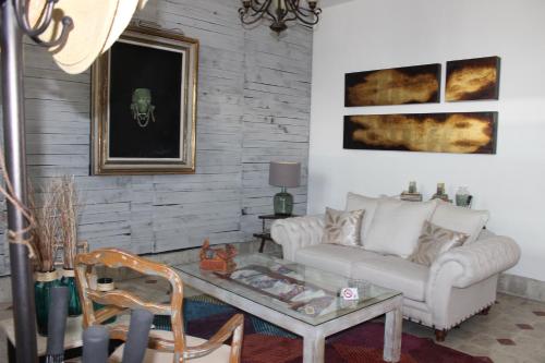 a living room with a couch and a coffee table at Casa Akbal B&B in Mérida