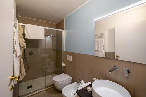 a bathroom with a sink and a toilet and a shower at Le Stanze del Lago Suites & Pool in Como