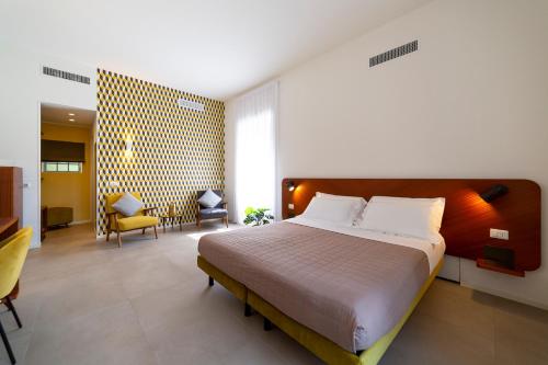 a bedroom with a large bed and a living room at Le Stanze del Lago Suites & Pool in Como