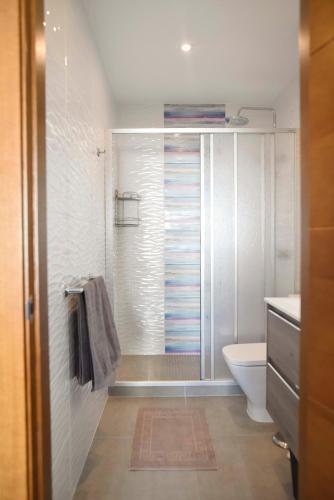 a bathroom with a shower with a toilet and a sink at Blanca Boutique Hotel in Jávea