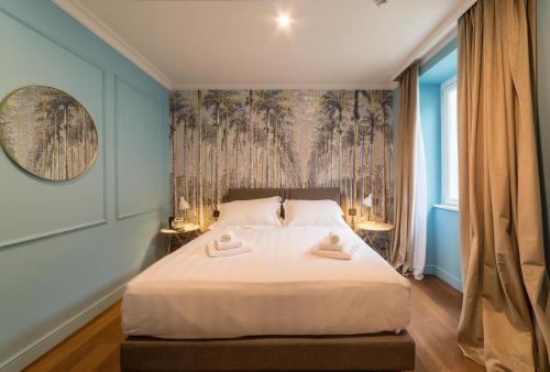 a bedroom with a bed with two towels on it at Palazzo 42 - Boutique Hotel & Suites in Pistoia