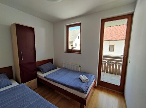 a bedroom with two beds and a window at Apartments Bohinjc in Bohinj