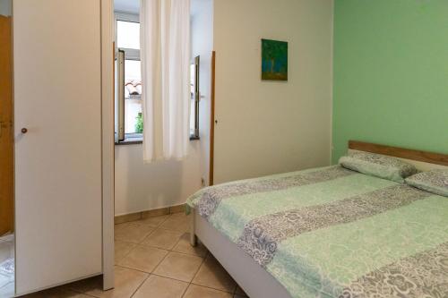 a bedroom with two beds and a window at Altstadt in Lovran