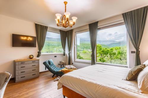 a bedroom with a bed and a large window at Stone House Korita in Otok