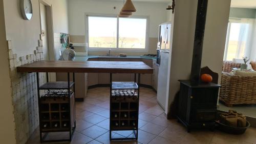 a kitchen with a large table in the middle of it at Olives in Arad