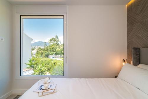 a bedroom with a bed and a large window at Exclusive House located in Prime location in Marbella