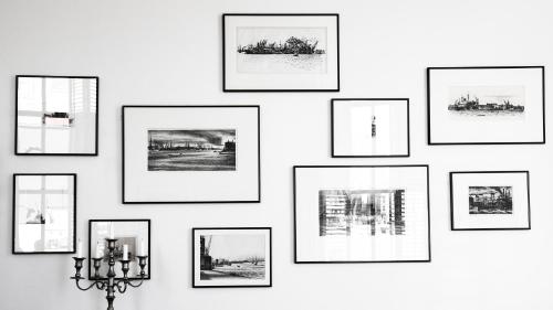 a group of framed pictures on a wall at Suitehotel Pincoffs in Rotterdam