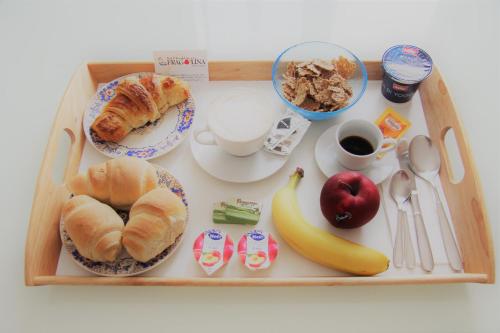 a tray with breakfast foods and coffee on a table at Fragolina B&B in Furci Siculo