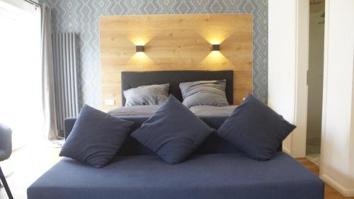 a bed with four pillows on top of it at Gasthaus am Henriettenhof in Grömitz