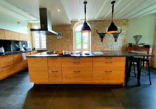a kitchen with a large island in the middle at Le Moulin Neuf in Ancy-le-Franc