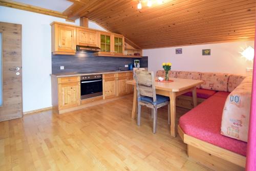 a kitchen and dining room with a table and a couch at Gailerhof in Liesing