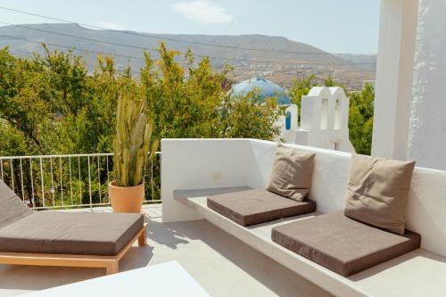 a balcony with chairs and a view of the mountains at Rooftop House in the old town of Parikia - Paros in Parikia