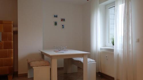 a white room with a table and a window at Ferienwohnungen Göhren in Göhren