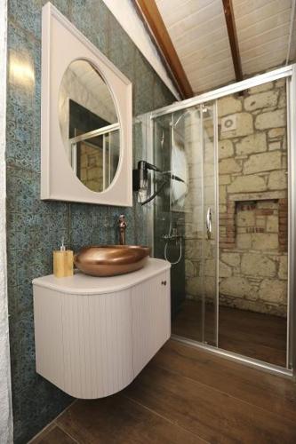 a bathroom with a sink and a glass shower at LA BİEN ALAÇATI in Cesme