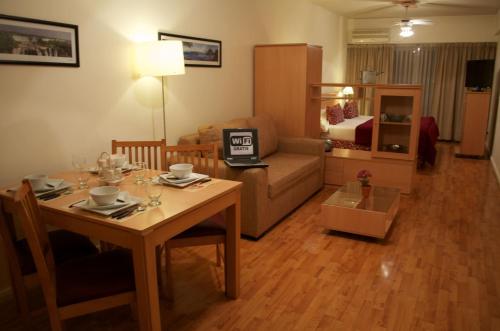 a living room with a table and a couch at Apart San Diego Recoleta in Buenos Aires