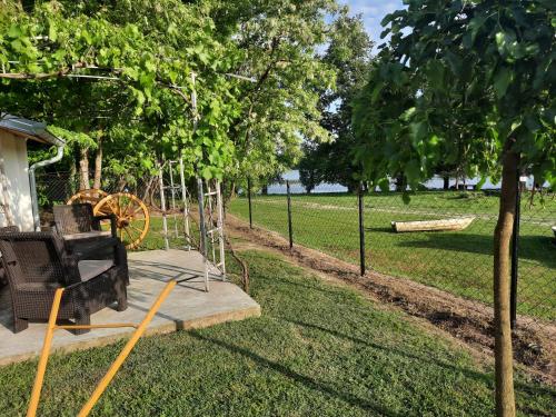 a park with a bench and a swing at Vila Sava in Jarak