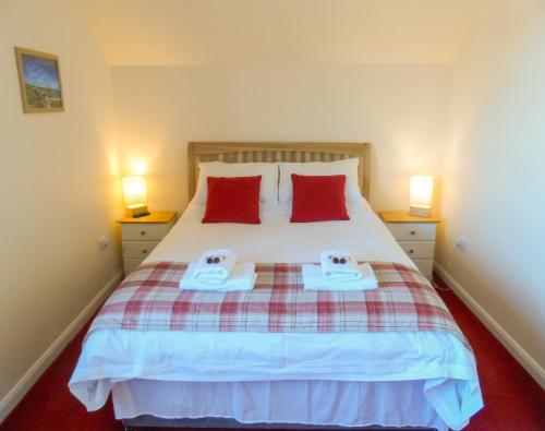 a bedroom with a bed with two towels on it at Seaview Apartment in Keiss