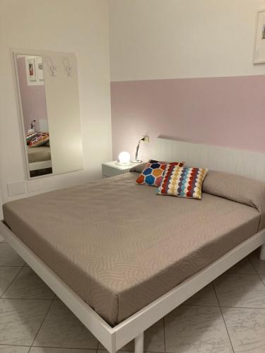 a large bed in a bedroom with a mirror at Fruttadamare in Porto Recanati