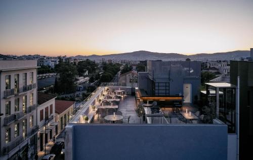 a view of a city with tables and chairs on a building at MiraMe Athens Boutique Hotel in Athens