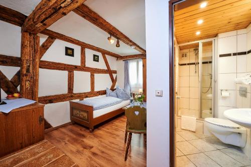 a bathroom with a bed and a sink and a toilet at Hotel-Gasthof Bub in Zirndorf