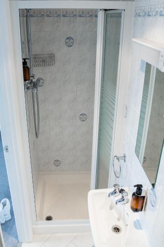 a bathroom with a shower and a sink at Kingsway Guesthouse - A selection of Single, Double and Family Rooms in a Central Location in Scarborough