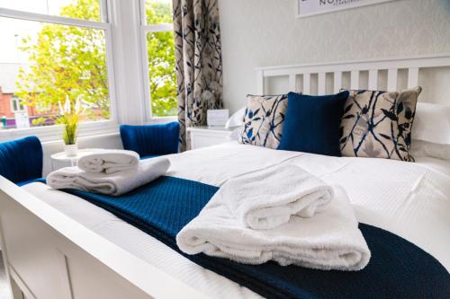 a bedroom with a bed with towels on it at Kingsway Guesthouse - A selection of Single, Double and Family Rooms in a Central Location in Scarborough