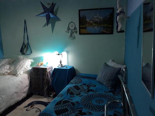 a bedroom with a bed and a table with a lamp at AL-Almada-2 in Porto