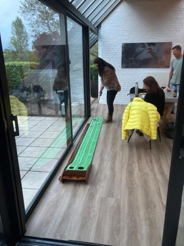 a group of people in a room with a sliding glass door at Rue Haute by M&M 4 sterren bed en breakfast vlakbij Maastricht in Eben-Emael