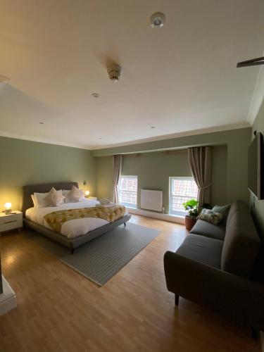 a large bedroom with a bed and a couch at The Fort York in York