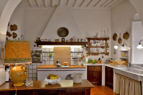 a kitchen with a table with a vase on it at Villa Carlotta con piscina in Lari