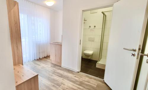 a bathroom with a shower and a toilet in it at Hotel Da Sabino in Singen