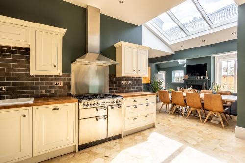 a kitchen with white cabinets and a stove at No1 Apartments & Bedrooms St Andrews - St Mary's in St. Andrews