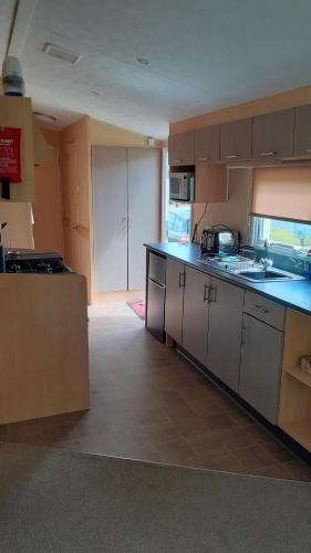 a kitchen with a sink and a counter top at Fairways 21...Turnberry in Girvan
